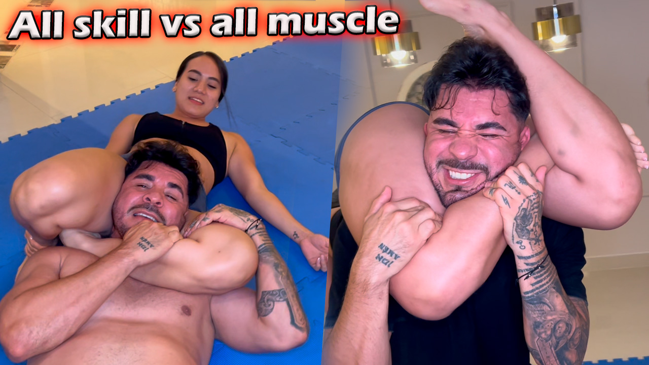 Athletic woman out wrestles a muscular man during a mixed wrestling match