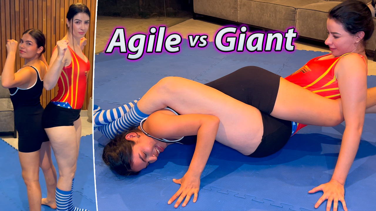 A tall woman engages in a wrestling match with a much shorter woman